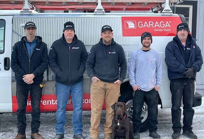 Laurent Door Systems technicians in front of a truck services